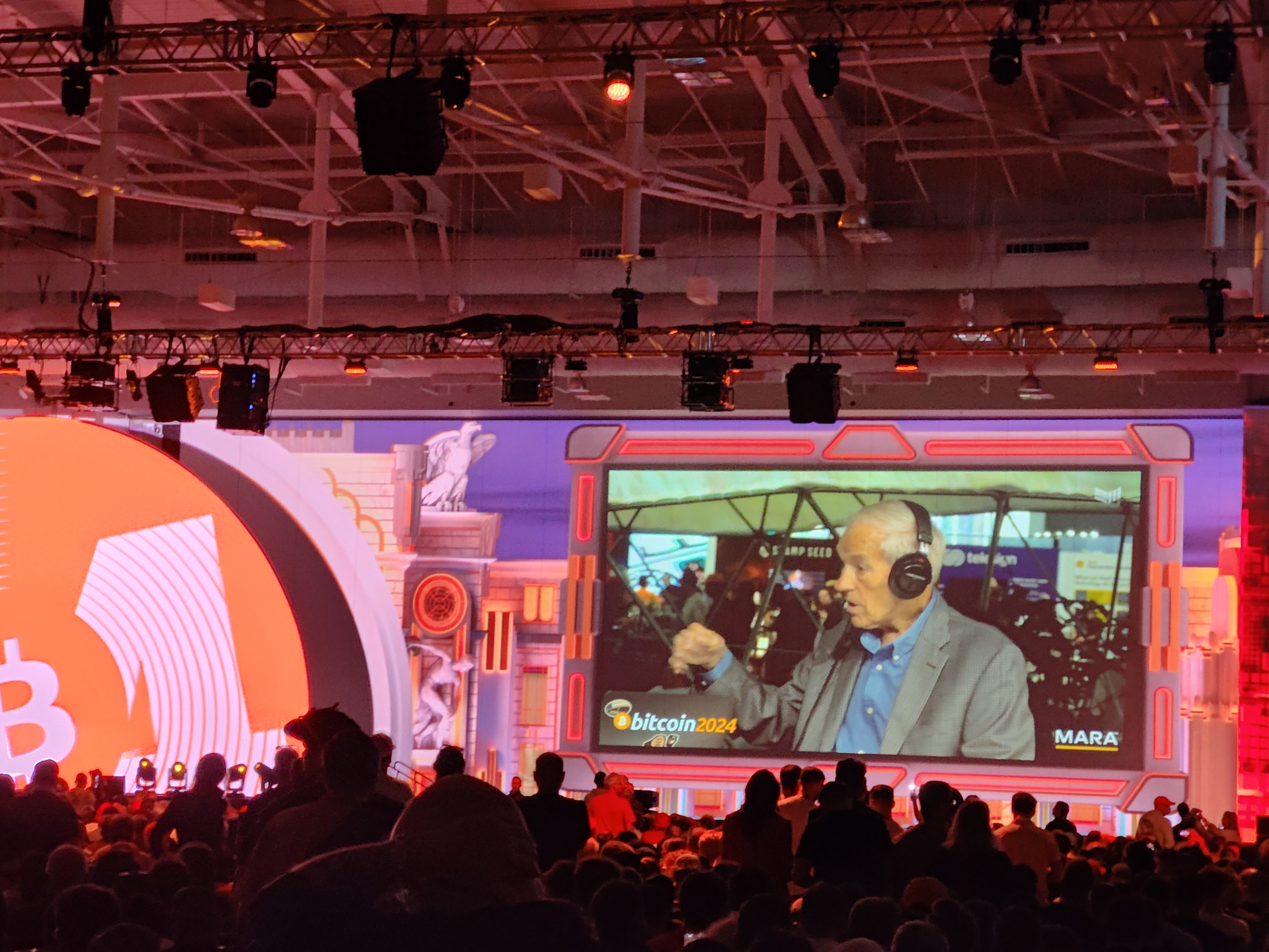 Ron Paul being interviewed on a large screen