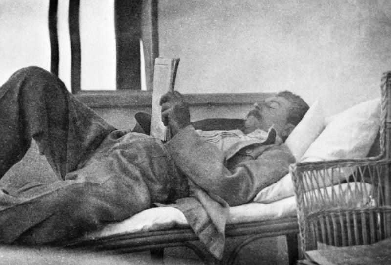 Stalin reading laid back on the couch