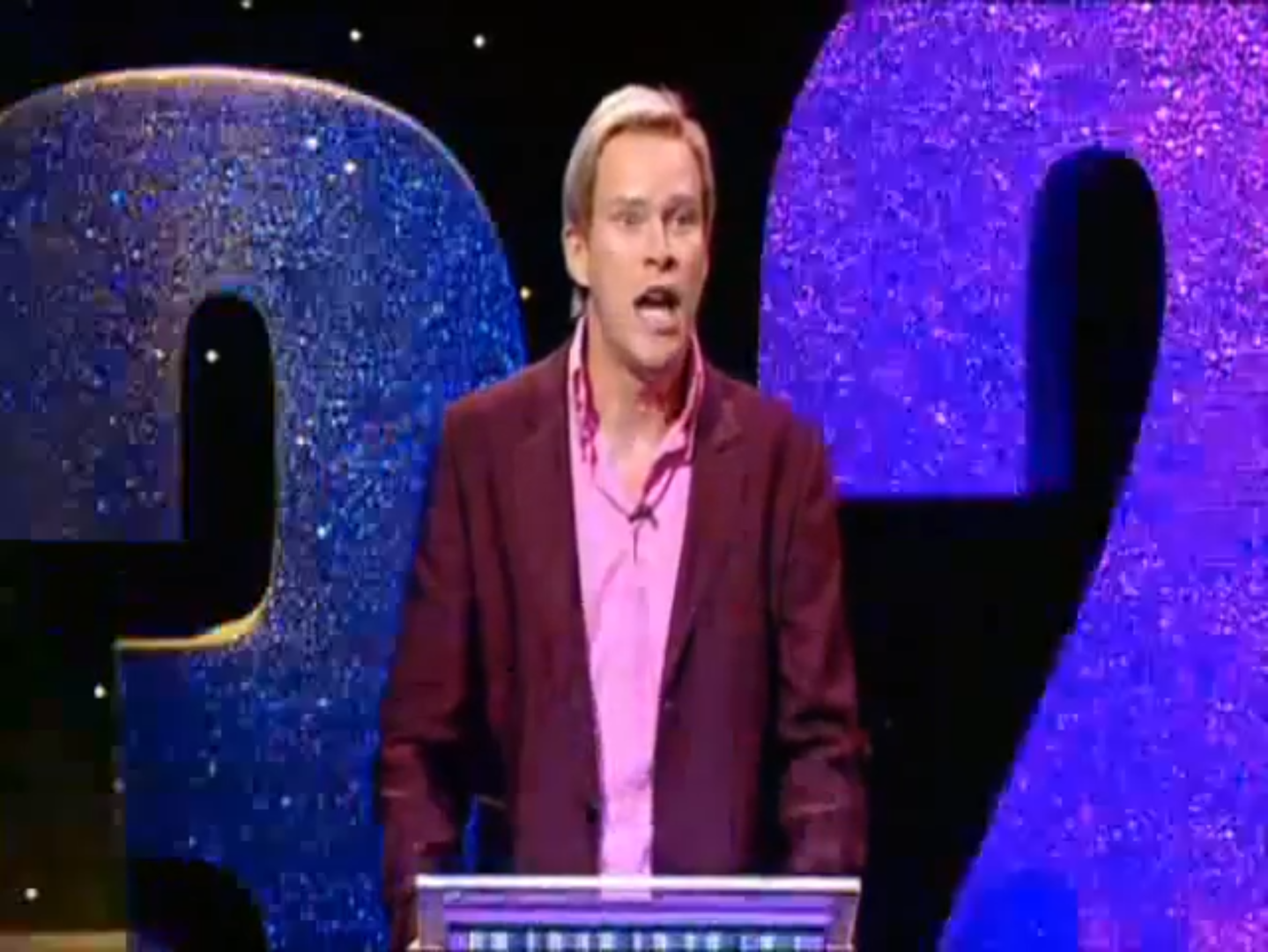 Host of Numberwang (played by Robert Webb) with a shocked expression