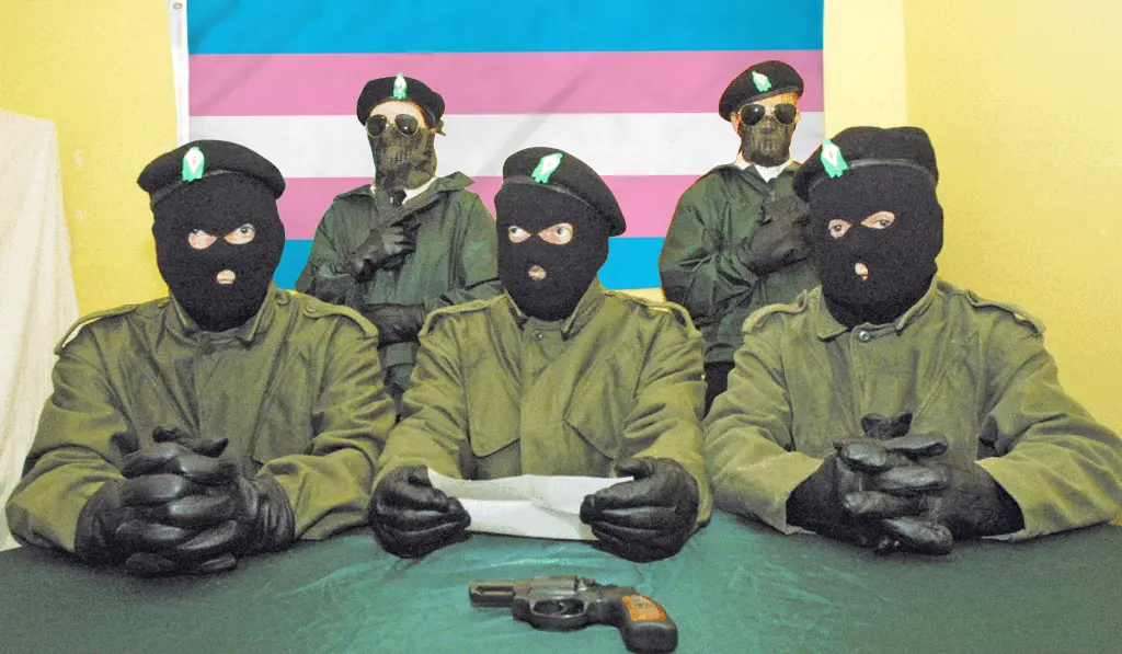 Photo of masked Real IRA members reading a message, except the Irish flag has been replaced with a trans flag.